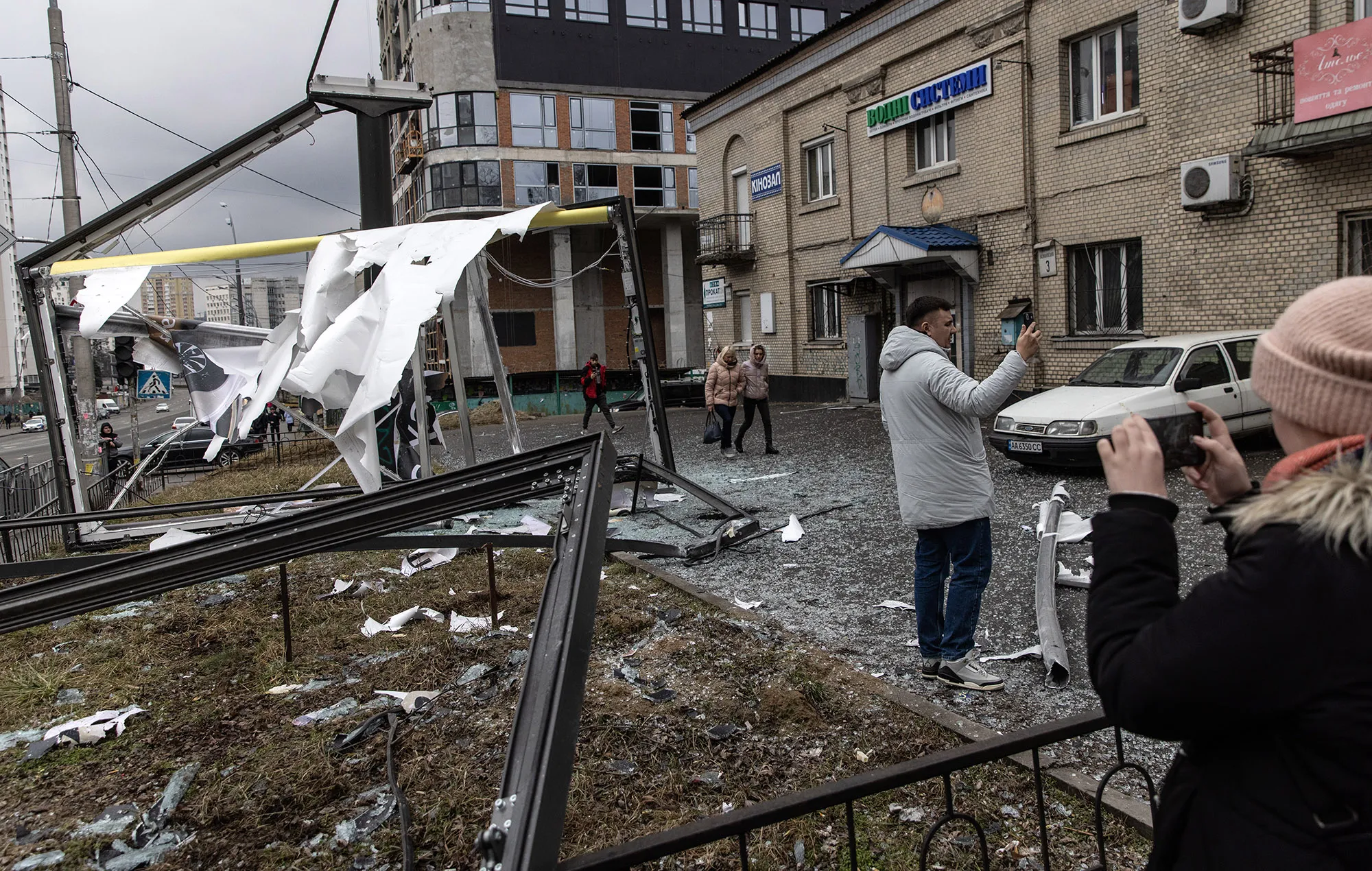 People take photos of damage in Kyiv, Ukraine&nbsp;on Feb. 24.&nbsp;