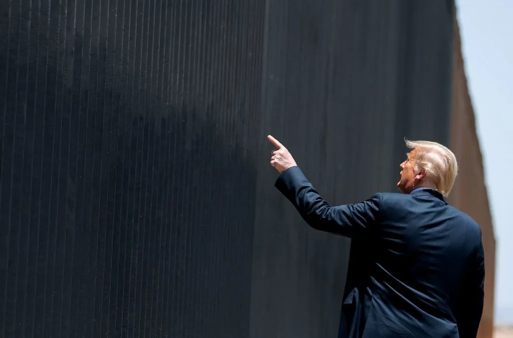 U.S. President Donald Trump inspects a section of wall during a ceremony at the border with Mexico in San Luis, Arizona in June.