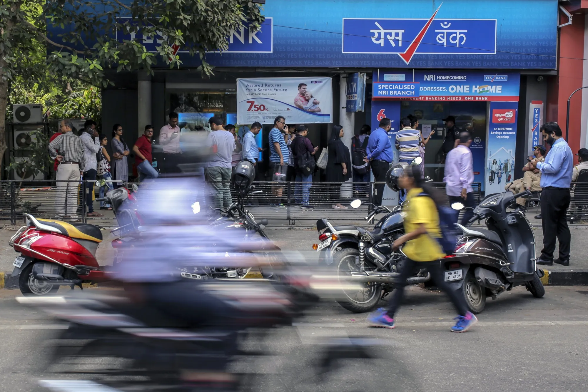 Customers stand&nbsp;in line outside a Yes Bank&nbsp;branch in Mumbai, India, in 2020.