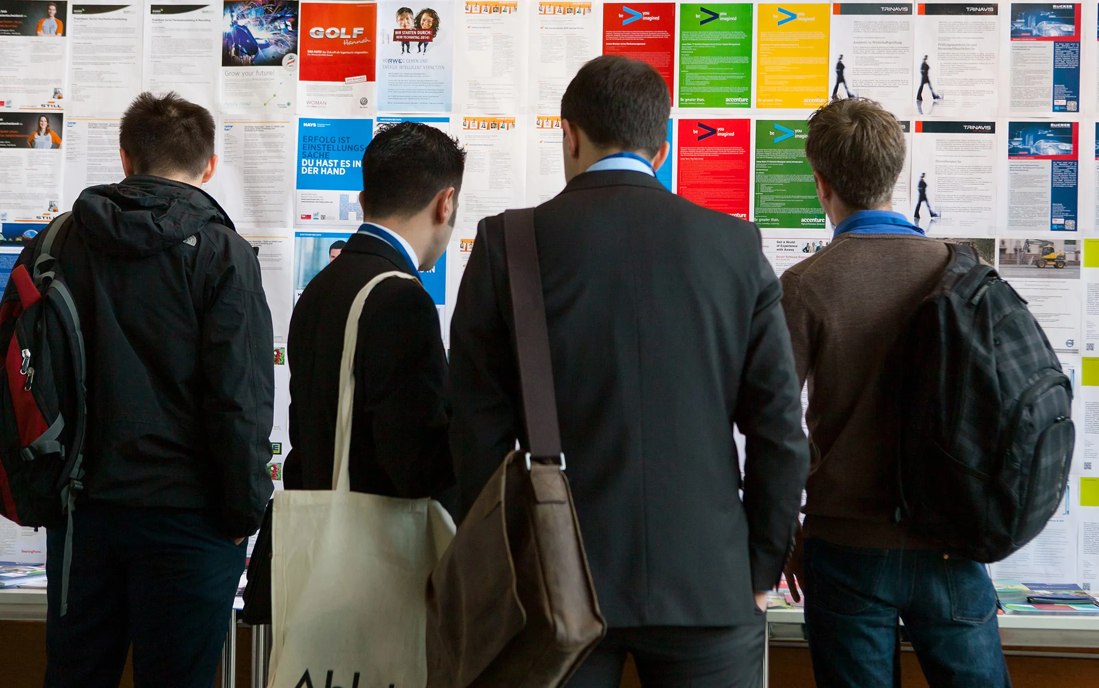Visitors look at employment opportunities displayed on a job board in Berlin.
