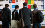 Visitors look at employment opportunities displayed on a job board in Berlin.
