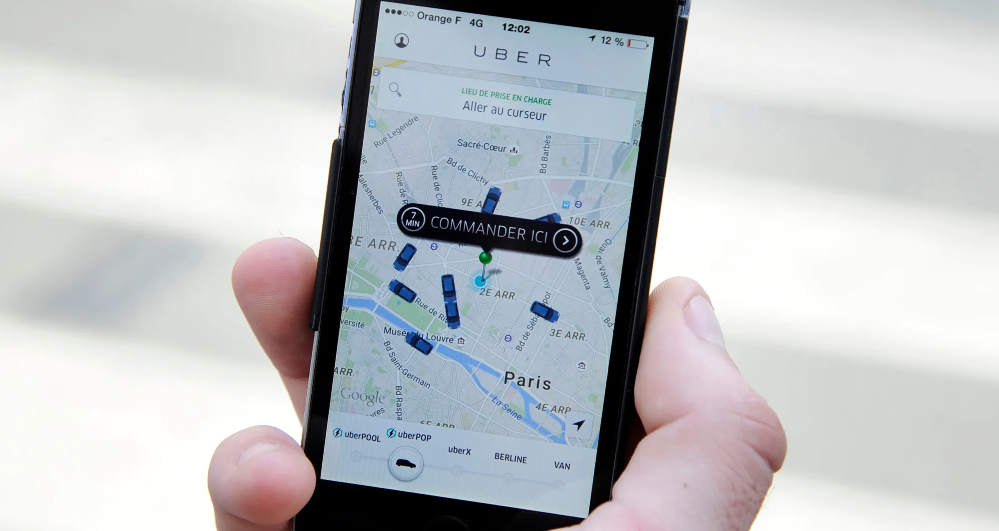 A person uses the French version of the Uber app in Paris.