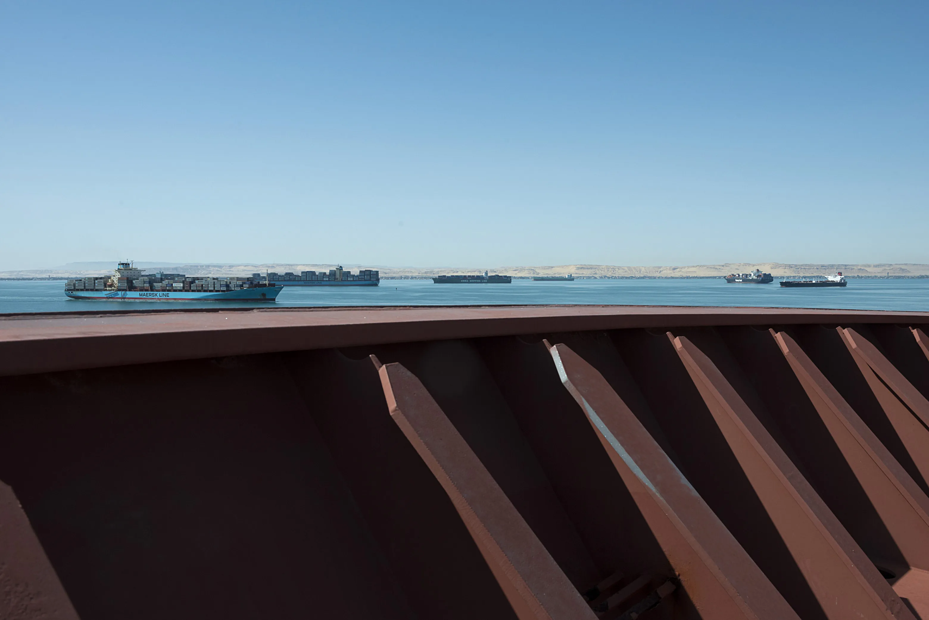 Commercial shipping vessels on the Great Bitter Lake during their passage though the Suez Canal.