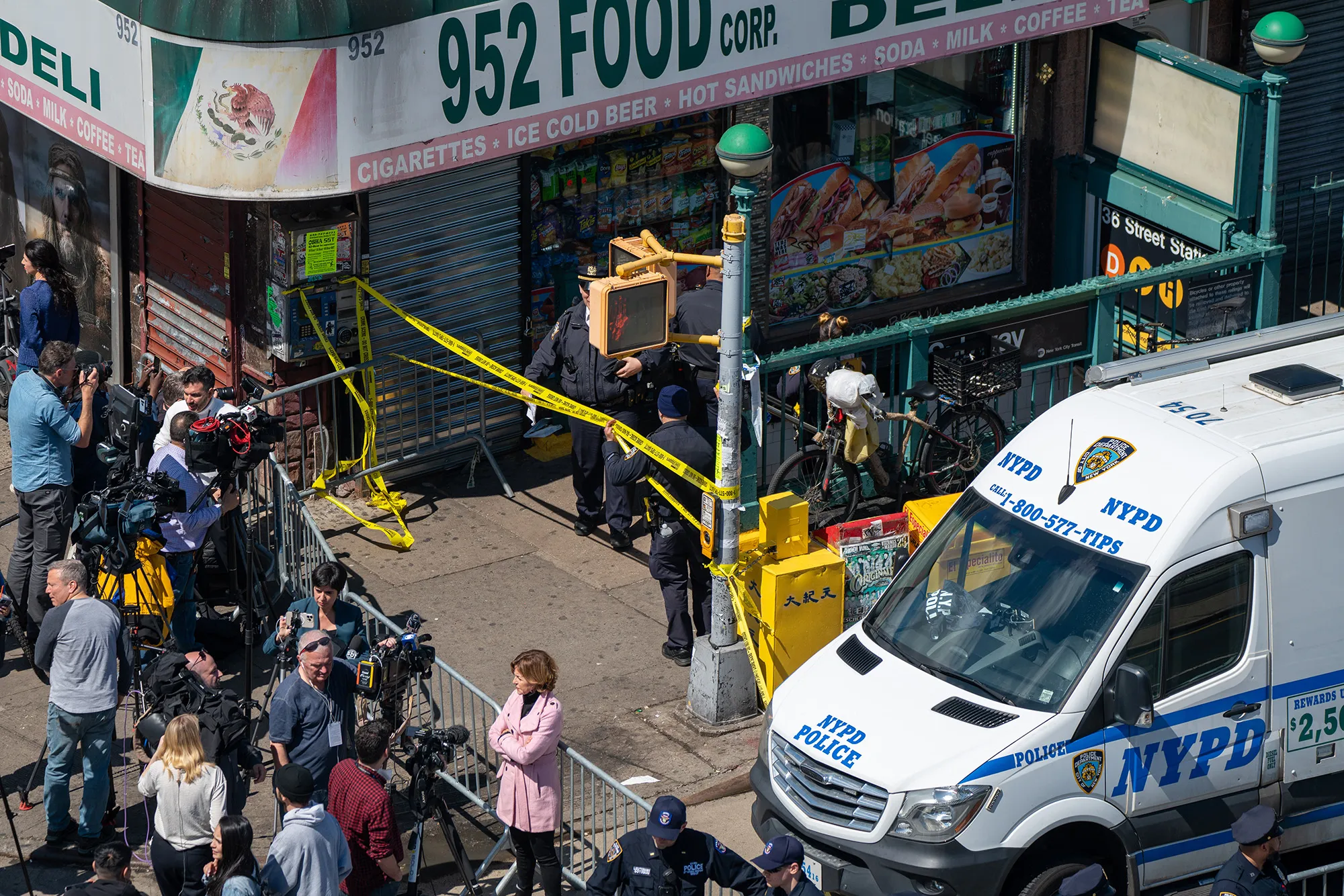 Members of the NYPD gather at the site of a shooting at the 36 St subway station in Brooklyn, New York on April 12.