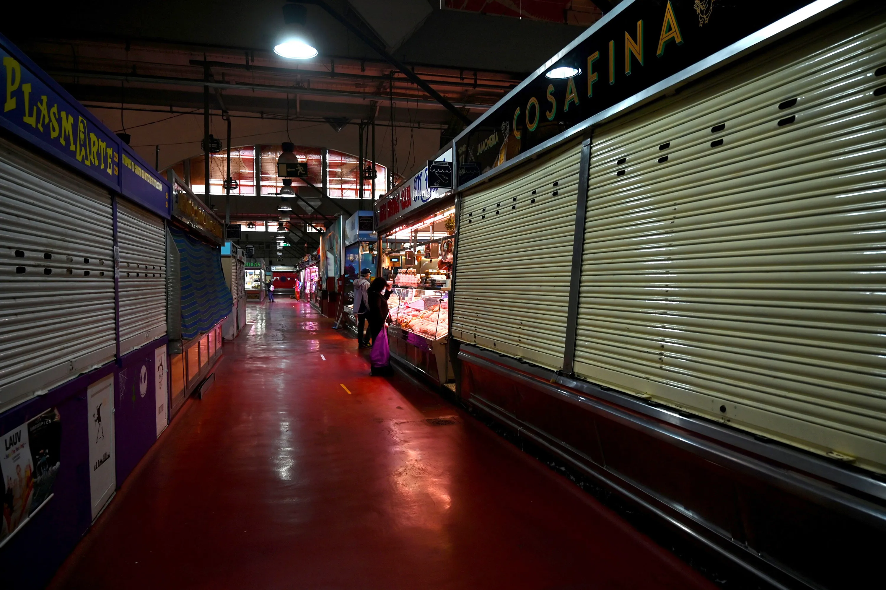 People shop at the Cebada market in Madrid on April 21.