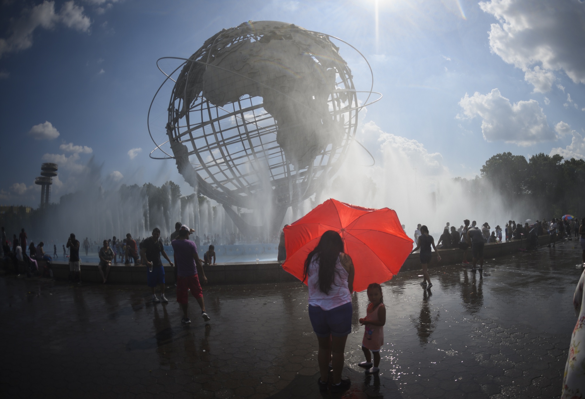 People cool off in the Unisphere fountain at Flushing Meadow Corona Park on July 21.