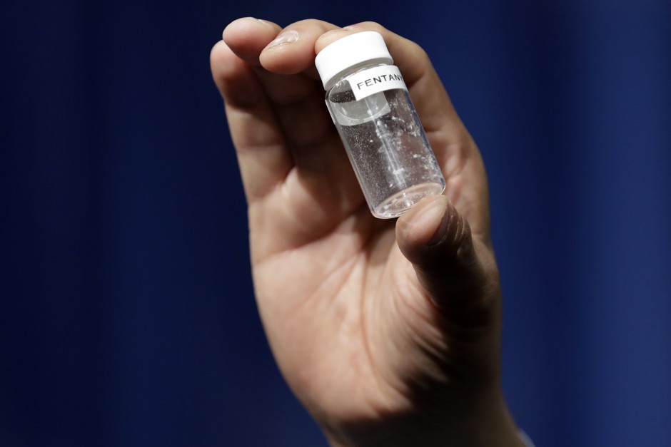 A reporter holds up an example of the amount of fentanyl that can be deadly.