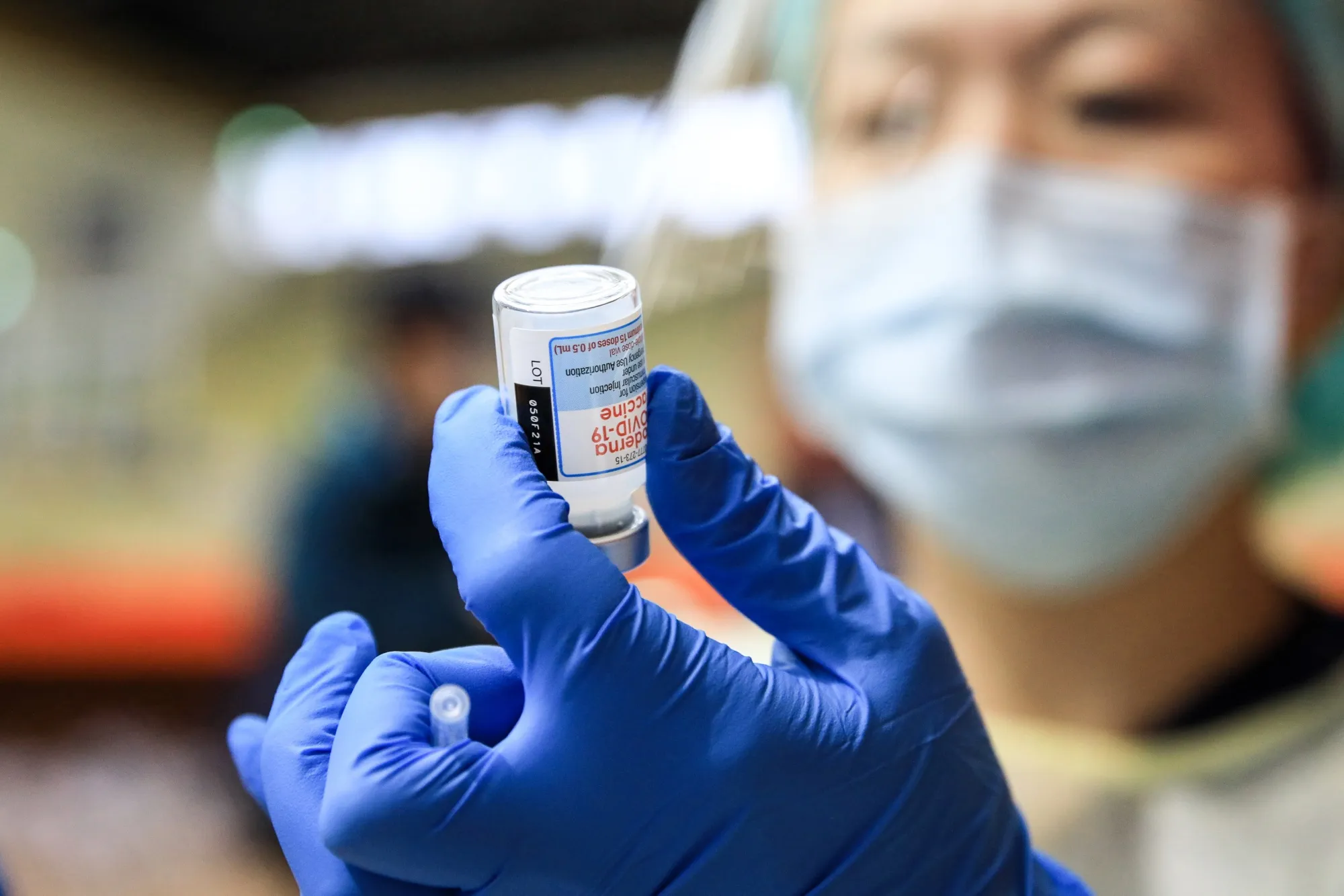 A healthcare worker prepares a dose of Moderna Covid-19 vaccine booster shot at a vaccination center in Keelung, Taiwan.