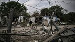 A girl rides her bicycle between the debris of destroyed homes after a strike in the city of Dobropillya,&nbsp;the eastern Ukrainian region of Donbas, on June 15.&nbsp;