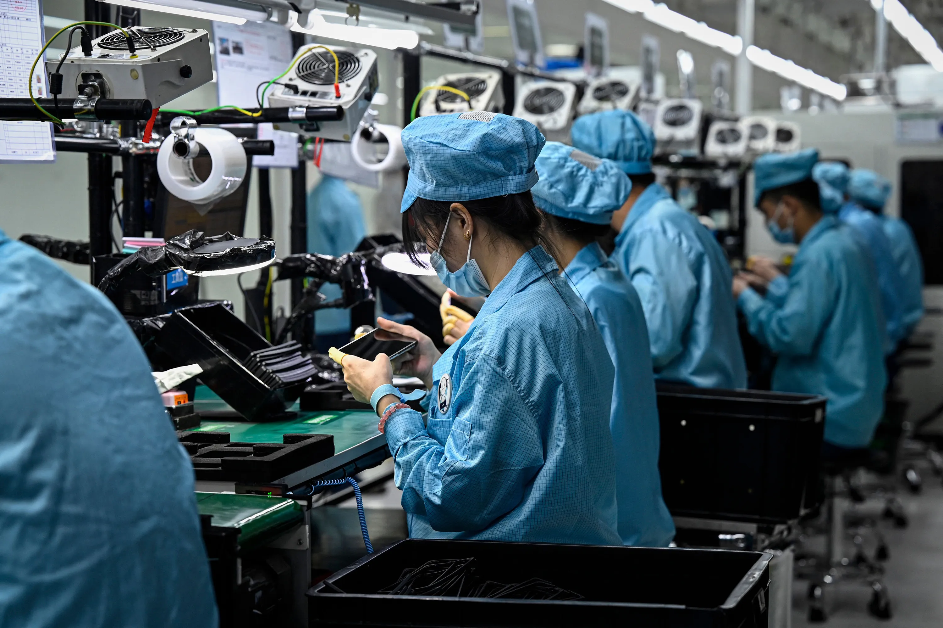 Employees working on a smartphone assembly line at a factory in Dongguan, Guangdong province, China.&nbsp;