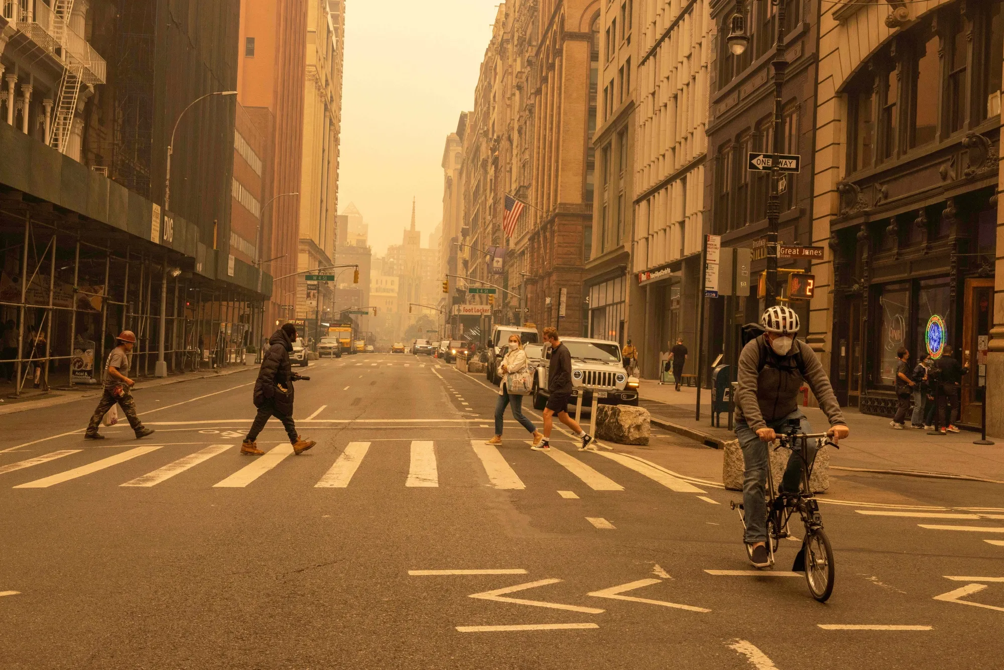 Pedestrians wear face masks as smoke from Canada wildfires blanketed&nbsp;New York on June 7.
