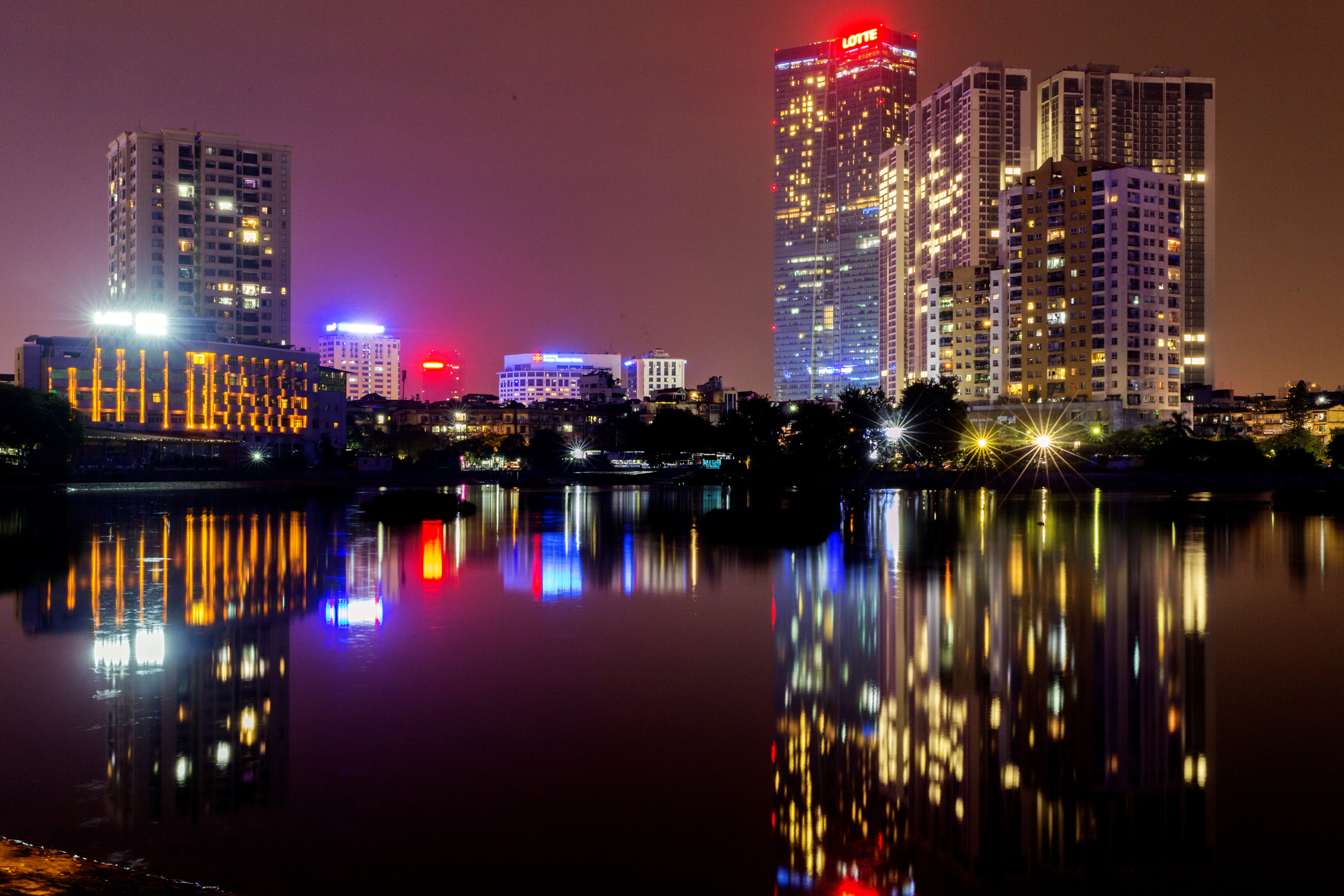 Buildings stand illuminated&nbsp;at night in Hanoi, Vietnam.