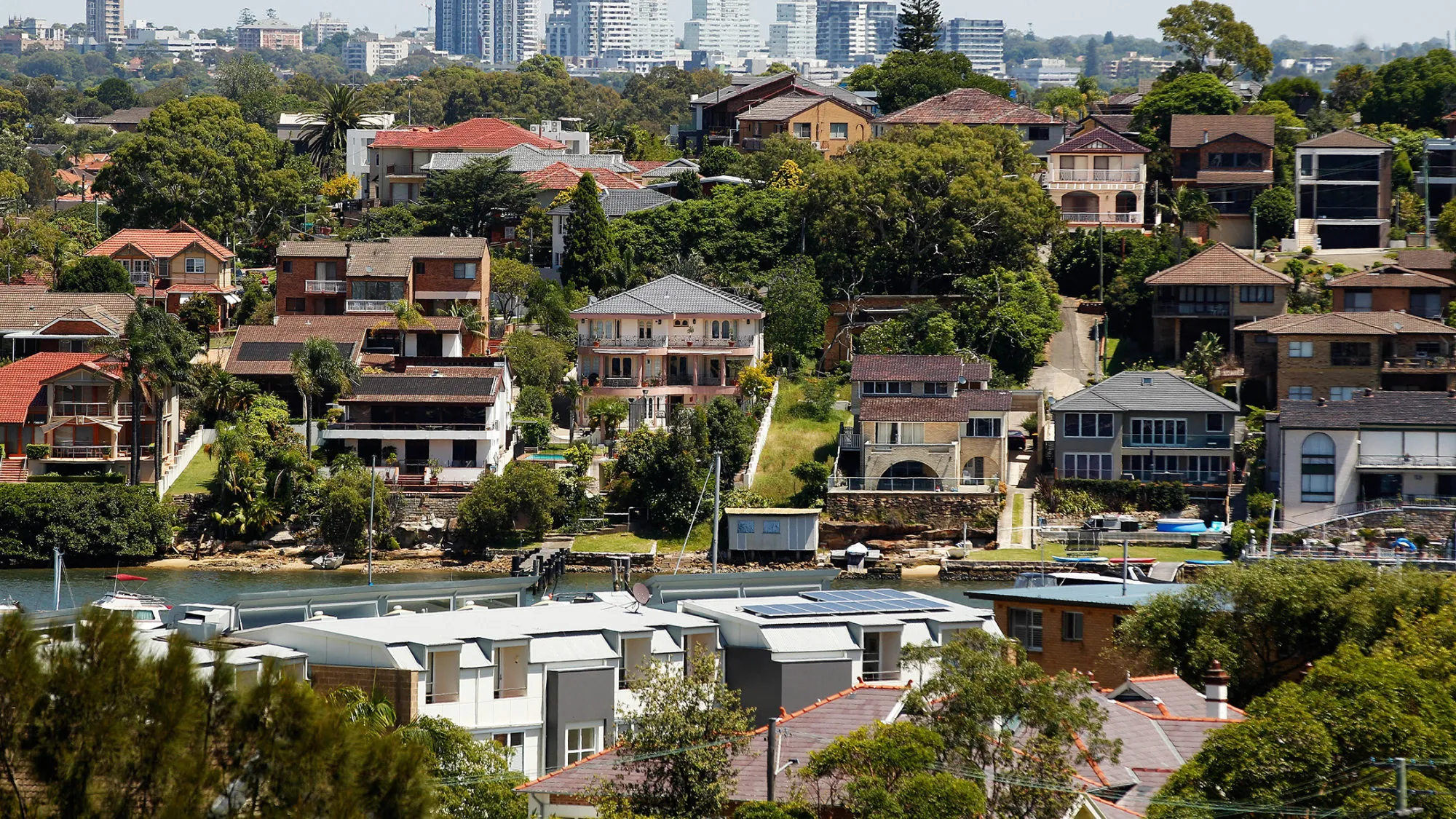 Houses stand in Sydney, Australia, on Wednesday, Feb. 17, 2016. Australia's opposition Labor Party is proposing scaling back tax breaks for landlords that have helped fuel a 50 percent increase in property prices in capital cities since 2008.
