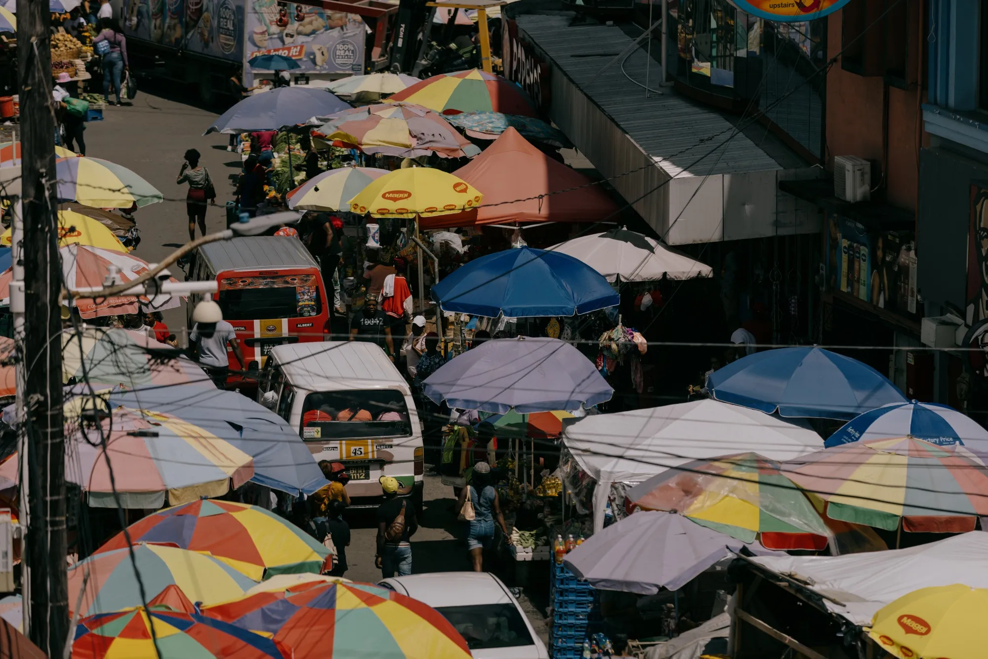 Shoppers pass by vendor stalls at the Stabroek Market in Georgetown, Guyana, on Tuesday, January 23, 2024. The small nation’s economy is one of the fastest-growing in the world.
