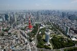 The Tokyo Tower, left, stands amid buildings in this aerial photograph taken in Tokyo, Japan, on Wednesday, June 24, 2015.
