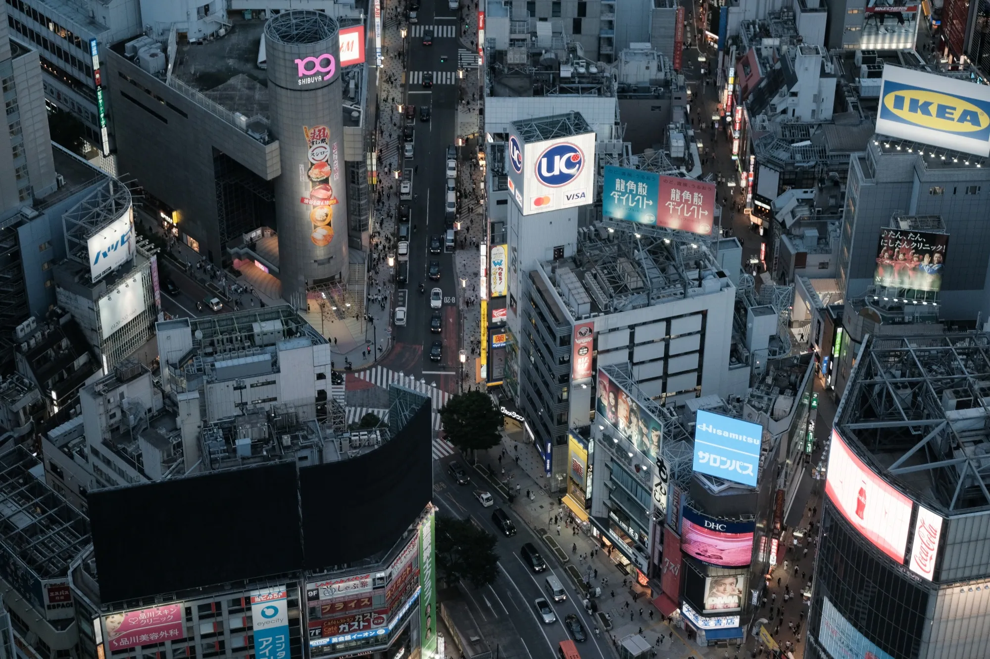 Commercial buildings at dusk in the Shibuya district of Tokyo.