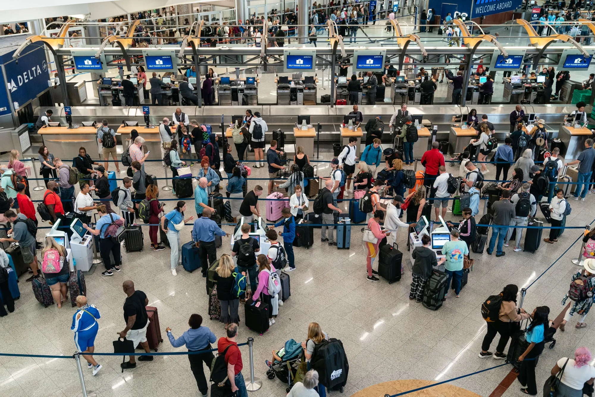 Travelers at Hartsfield-Jackson Atlanta International Airport in Atlanta.