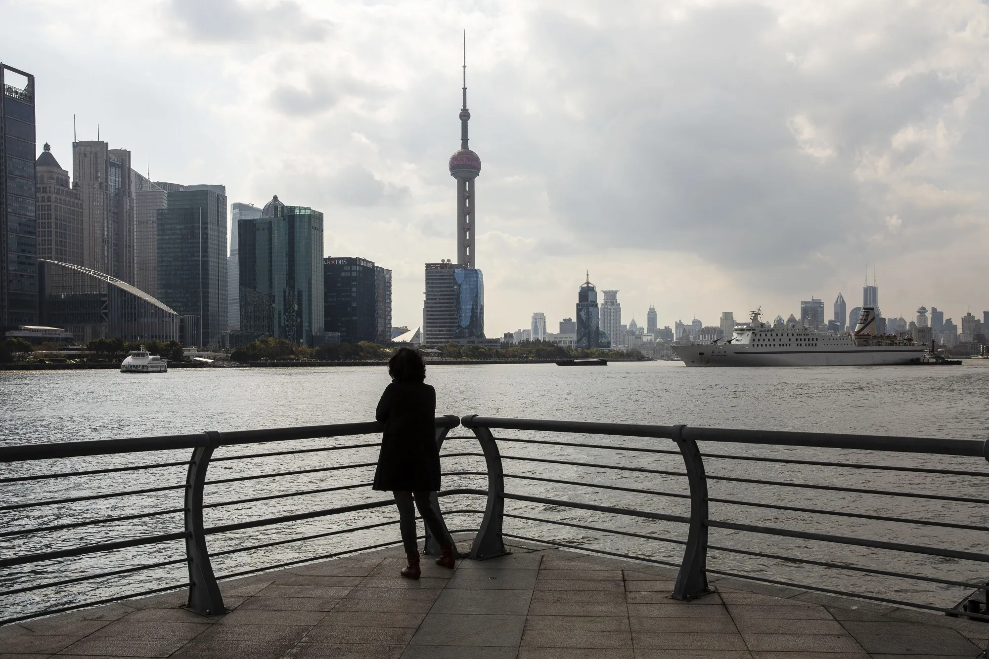 Skyscrapers of the Pudong Lujiazui Financial District stand across the Huangpu River in Shanghai, China.