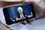 Warren Buffett, chairman and chief executive officer of Berkshire Hathaway Inc., speaks during the virtual Berkshire Hathaway annual shareholders meeting seen on a smartphone in Arlington, Virginia, U.S., on Saturday, May 2, 2020. Buffett, hosting the annual meeting virtually, has largely stayed in the shadows as the coronavirus pandemic hammered the global economy and stock markets.