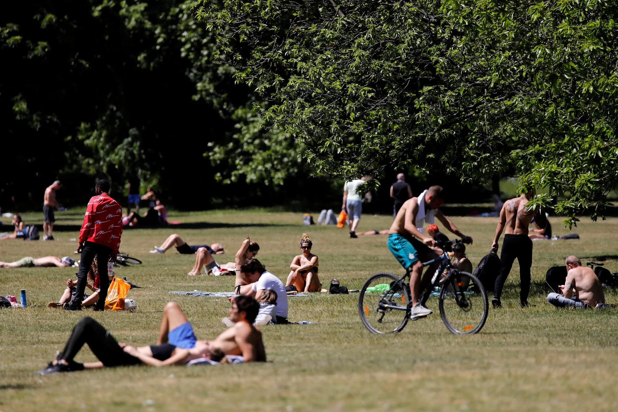 People sunbathe on the grass in Hyde Park, London, on May 19.
