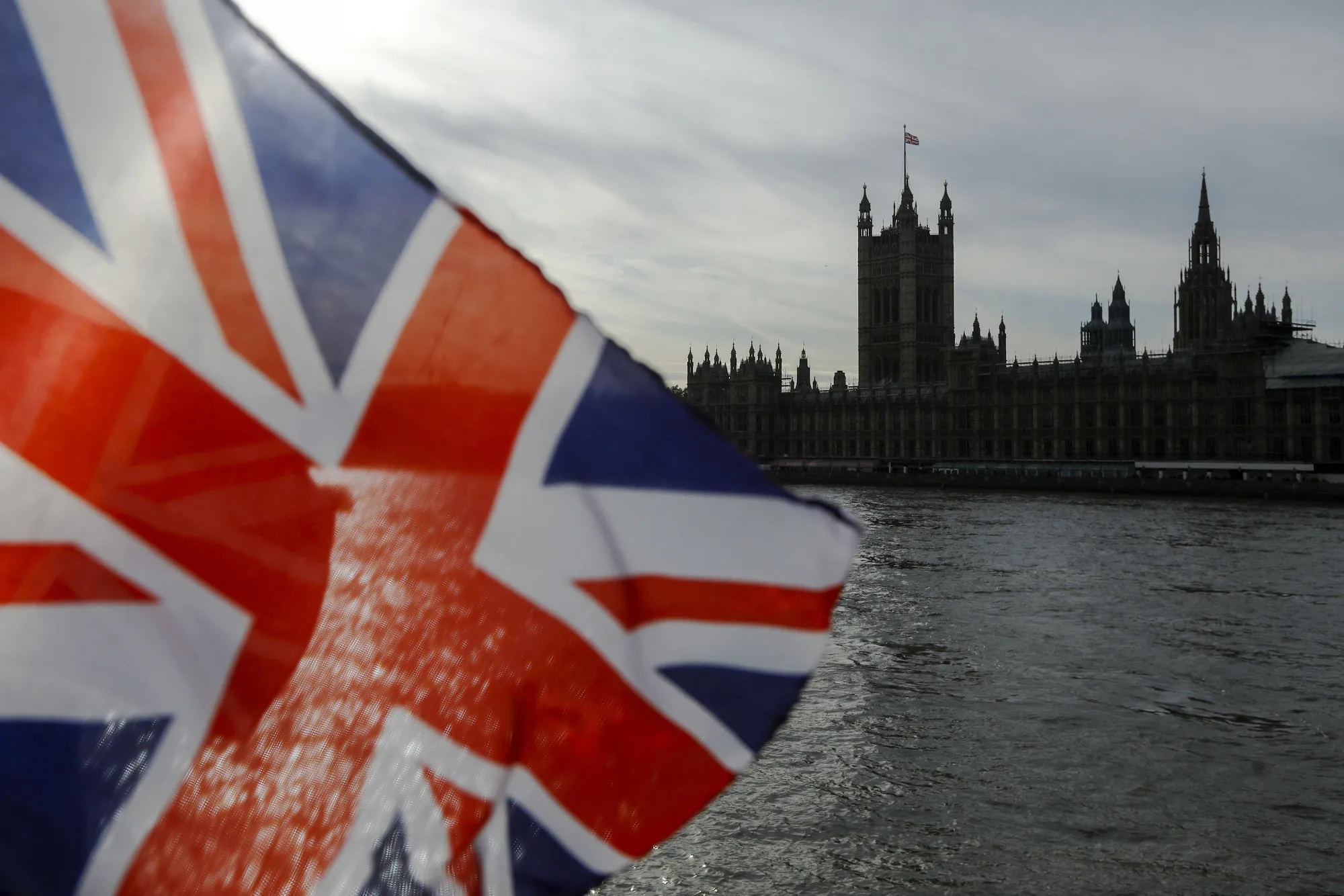 A UK flag flies on the bank of the River Thames in London.&nbsp;