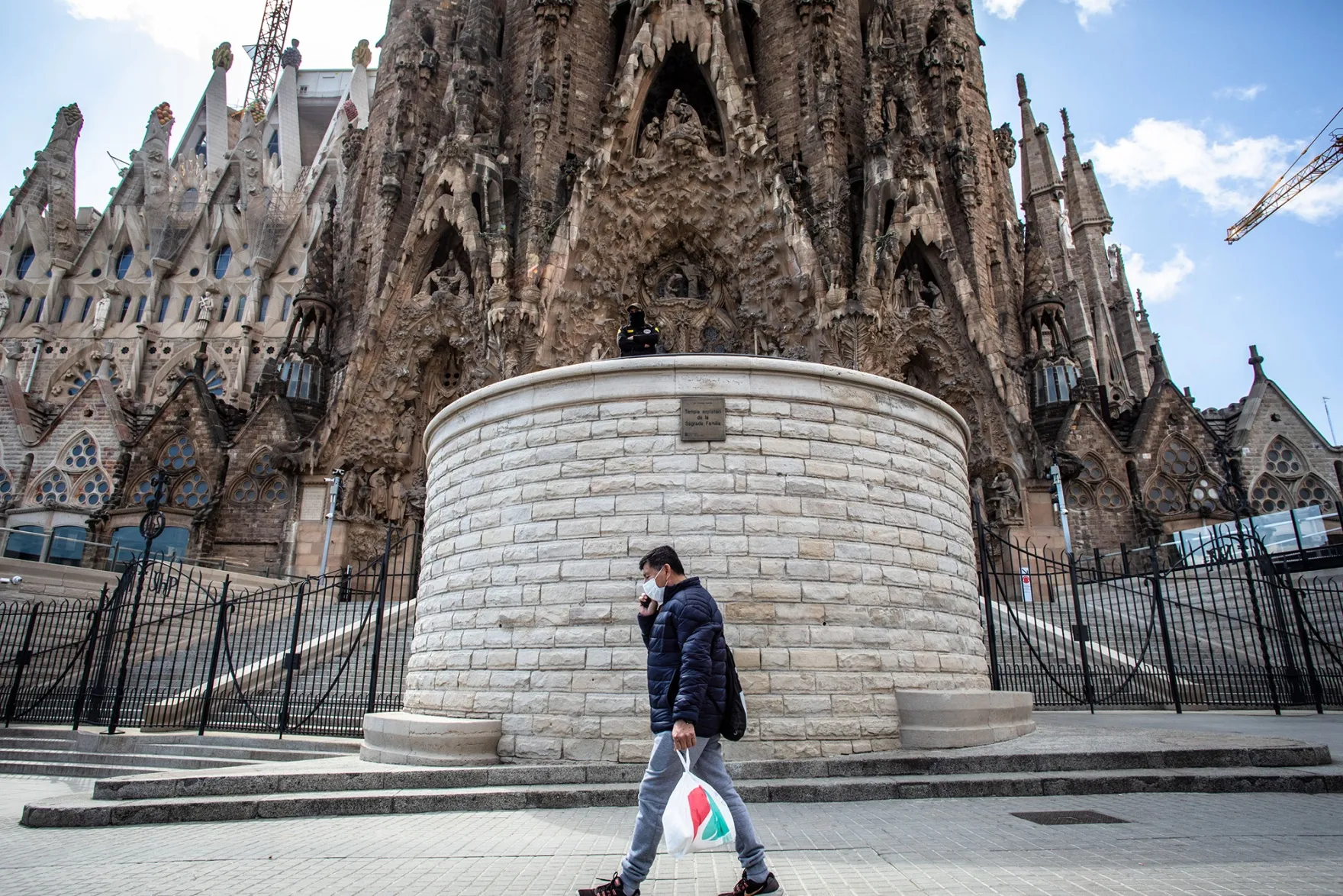 A pedestrian&nbsp;passes&nbsp;the Sagrada Familia cathedral in Barcelona.