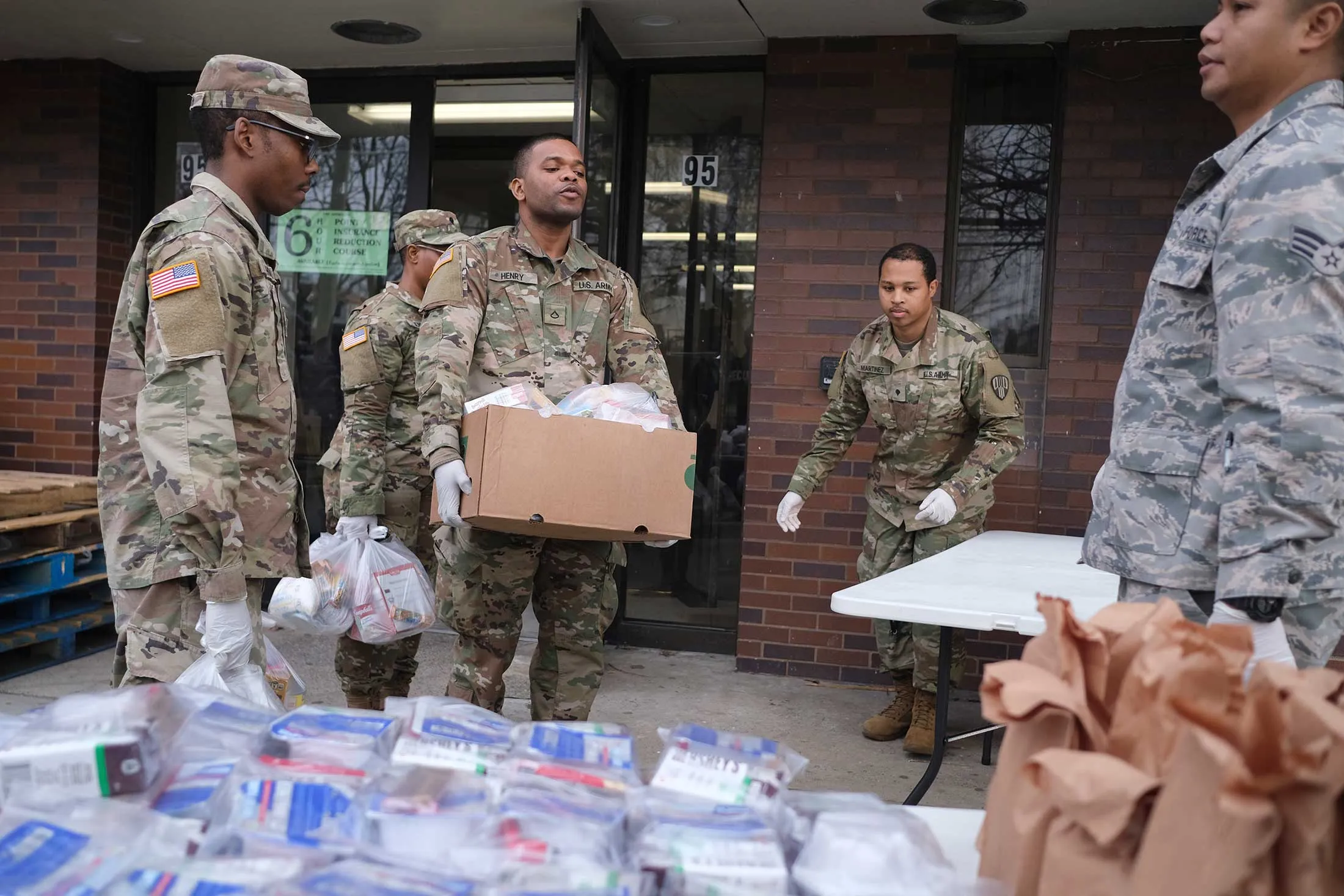 Members of the New York National Guard help to organize and distribute food to families on free or reduced school lunch programs in New Rochelle, N.Y., on March 12.