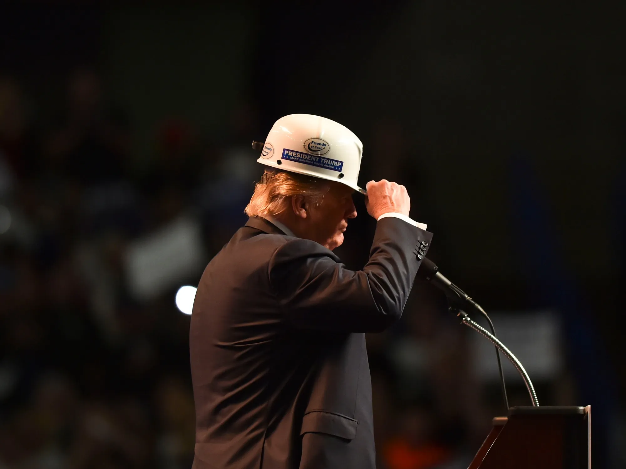 Donald Trump models a hard hat in support of coal miners during a campaign rally in Charleston.
