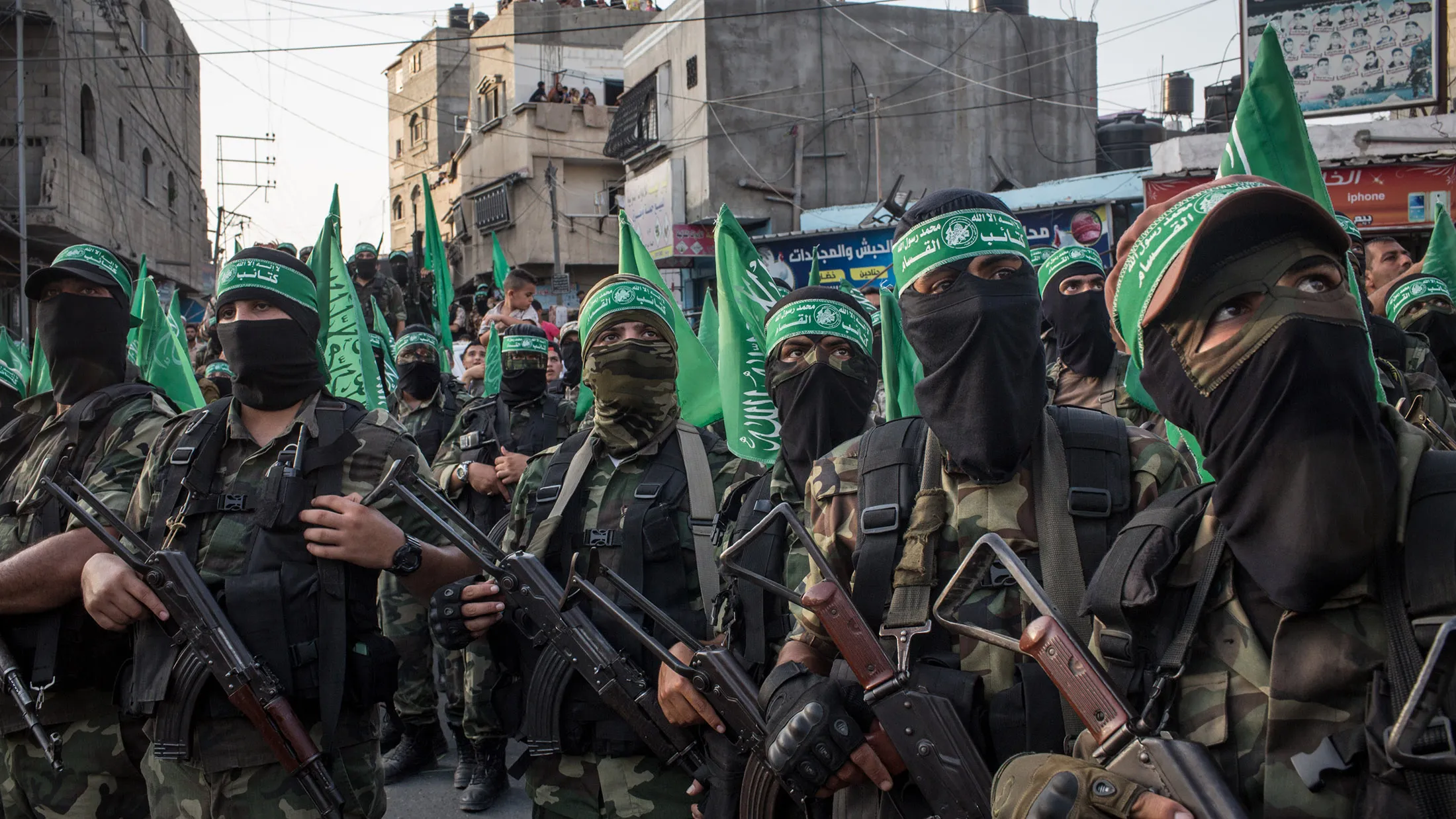 GAZA CITY, GAZA - JULY 20: Palestinian Hamas militants are seen during a military show in the Bani Suheila district on July 20, 2017 in Gaza City, Gaza. For the past ten years Gaza residents have lived with constant power shortages, in recent years these cuts have worsened, with supply of regular power limited to four hours a day. On June 11, 2017 Israel announced a new round of cuts at the request of the Palestinian authorities and the decision was seen as an attempt by President Mahmoud Abbas to pressure Gaza's Hamas leadership. Prior to the new cuts Gaza received 150 megawatts per day, far below it's requirements of 450 megawatts. In April, Gaza's sole power station which supplied 60 megawatts shut down, after running out of fuel, the three lines from Egypt, which provided 27 megawatts are rarely operational, leaving Gaza reliant on the 125 megawatts supplied by Israel's power plant. The new cuts now restrict electricity to three hours a day severely effecting hospital patients with chronic conditions and babies on life support. During blackout hours residents use private generators, solar panels and battery operated light sources to live. June 2017 also marked ten years since Israel began a land, sea and air blockade over Gaza. Under the blockade, movement of people and goods is restricted and exports and imports of raw materials have been banned. The restrictions have virtually cut off access for Gaza's two million residents to the outside world and unemployment rates have skyrocketed forcing many people into poverty and leaving approximately 80% of the population dependent on humanitarian aid.
