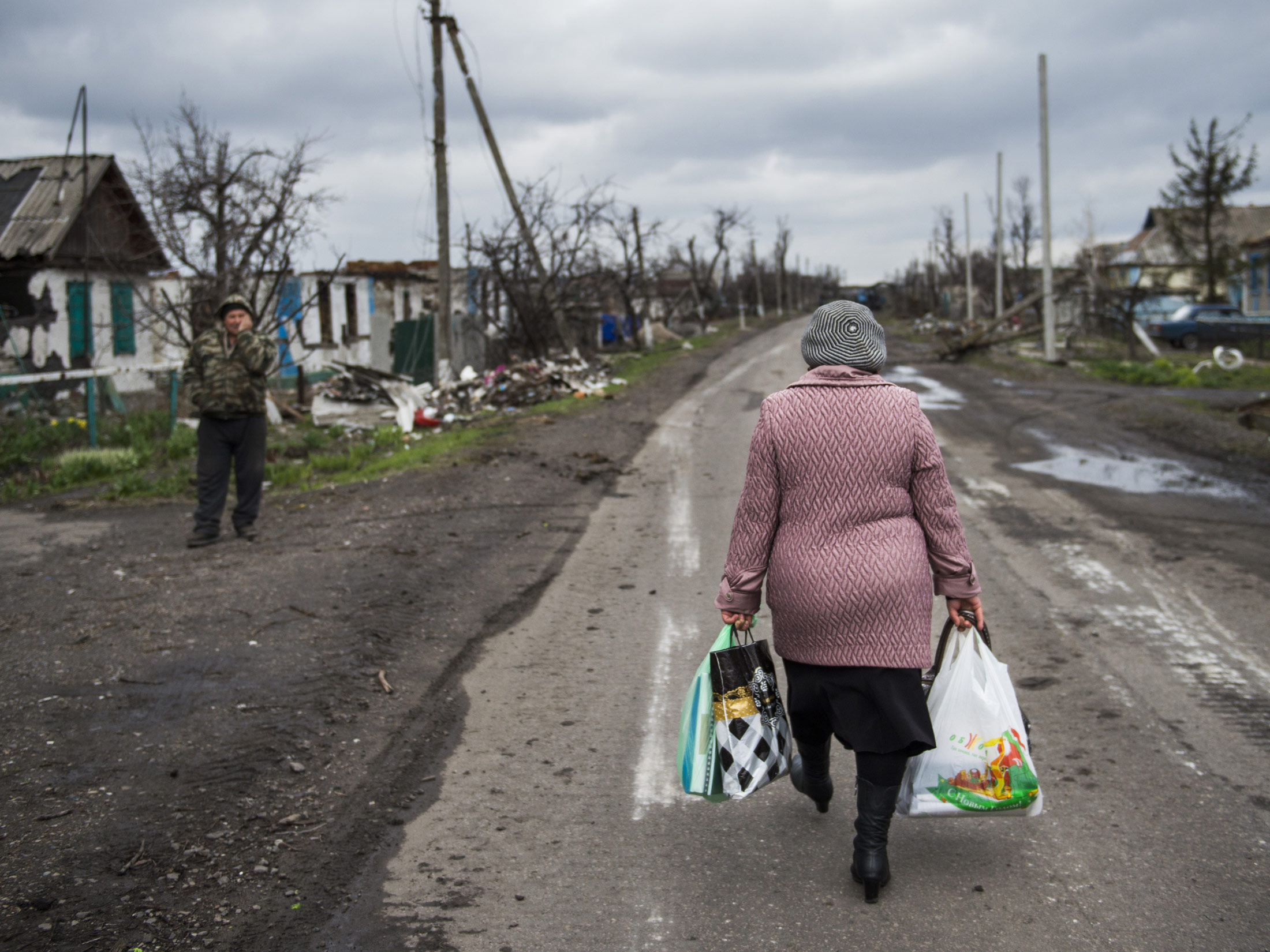 A woman carries walks back to the village of Nikishino in Ukraine, on April 21, 2015.
