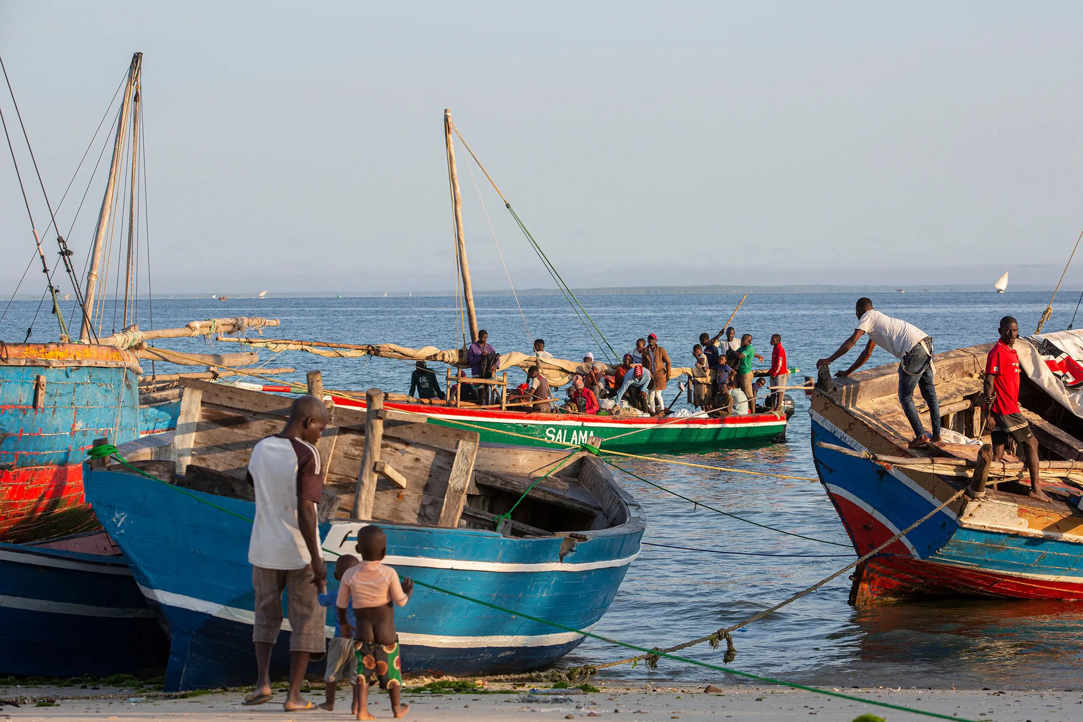 Fishermen tend to their boats on the shores of the Paquitequete neighborhood in Pemba, Mozambique.