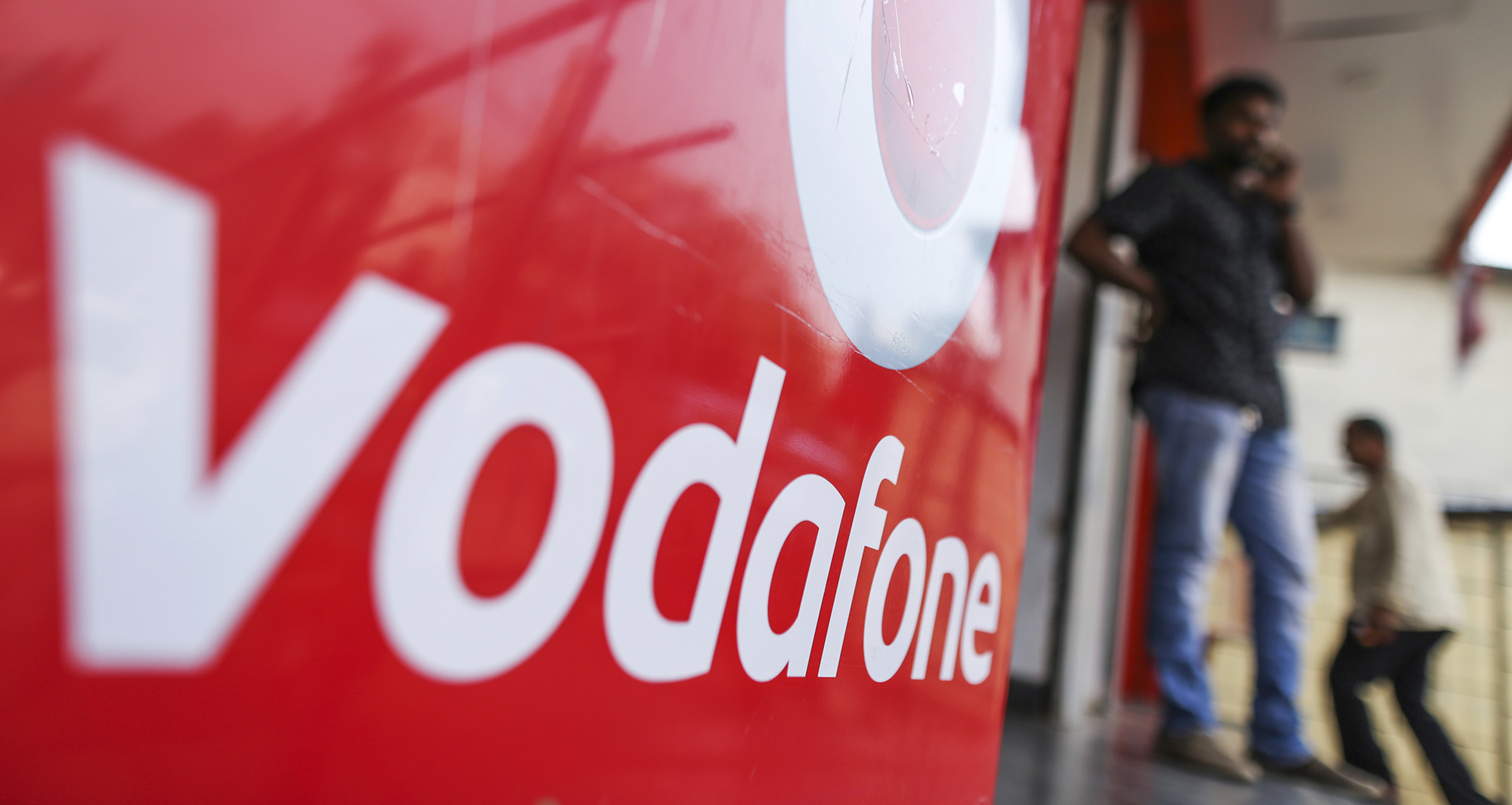 Signage for Vodafone Group Plc is displayed outside a Vodafone India Ltd. store in Mumbai.