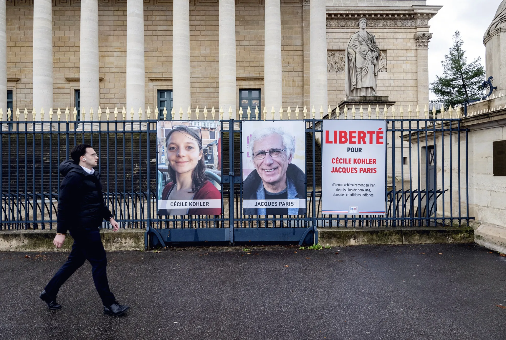 Placards featuring images of Cecile Kohler and Jacques Paris, in Paris in March.