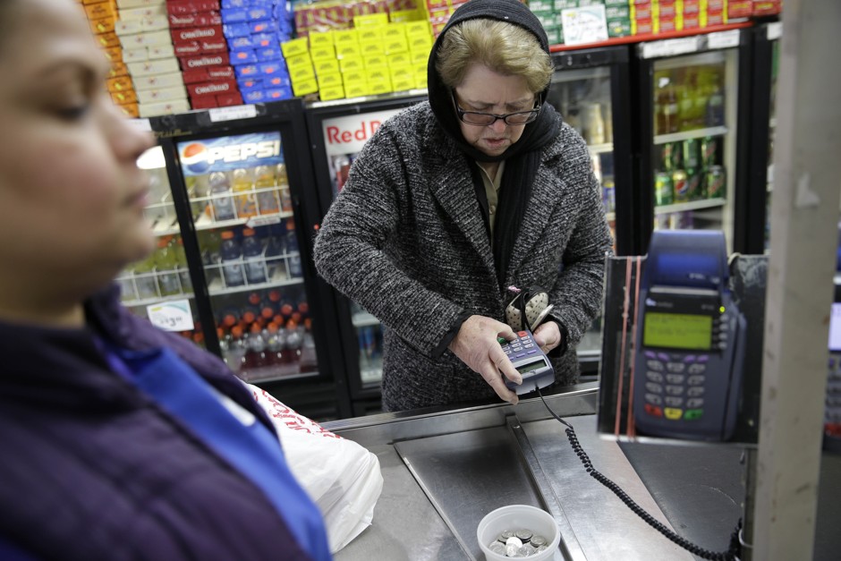 A woman pays for groceries in New Jersey using SNAP benefits.