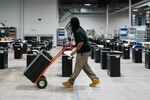 A worker wheels a box of 2020 Presidential election ballots to table for a hand-count during an audit&nbsp;in&nbsp;Georgia.