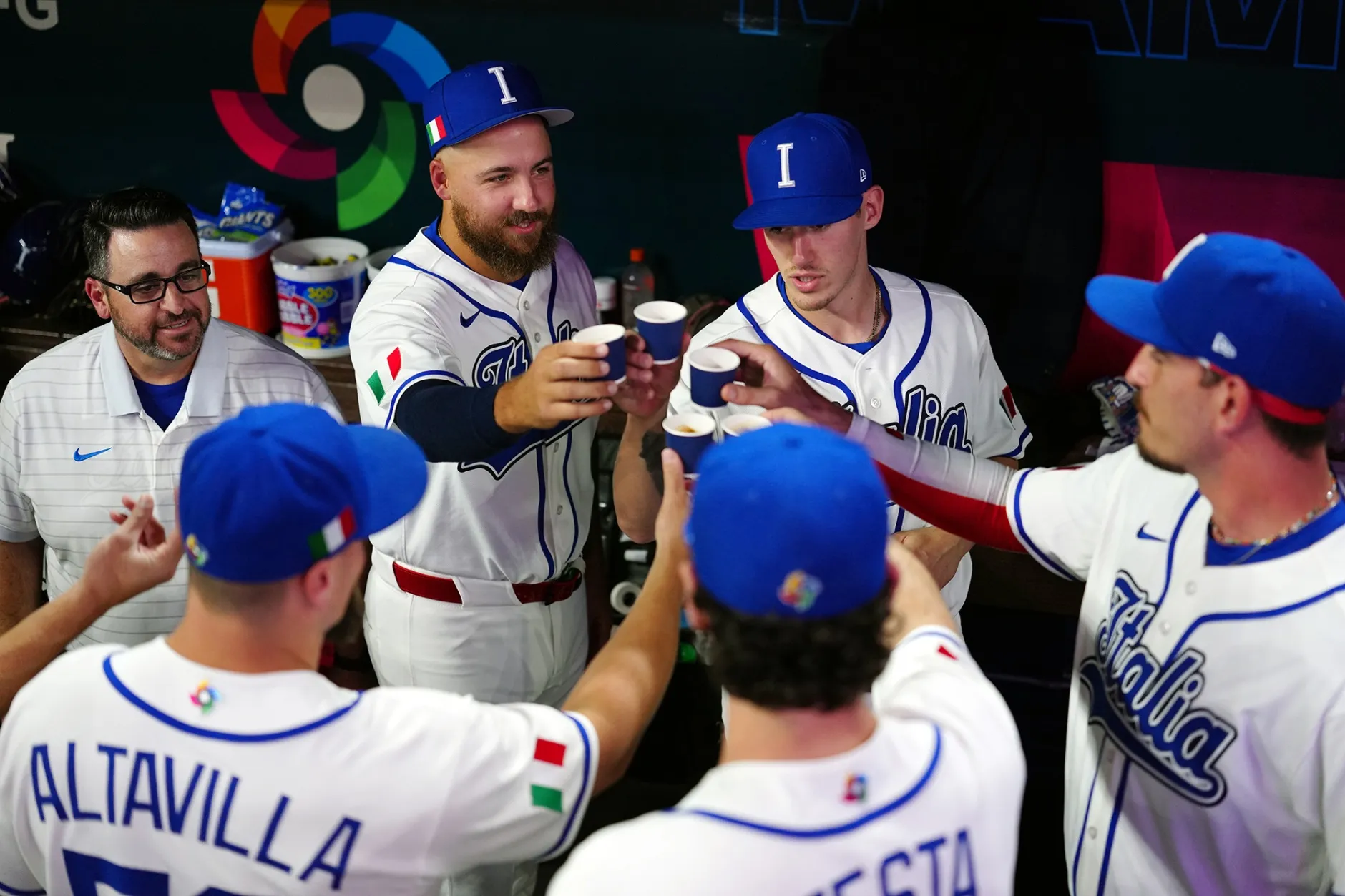 Members of Team Italy drink espresso in the dugout before the game against Team Venezuela at loanDepot park in Miami on March 16.