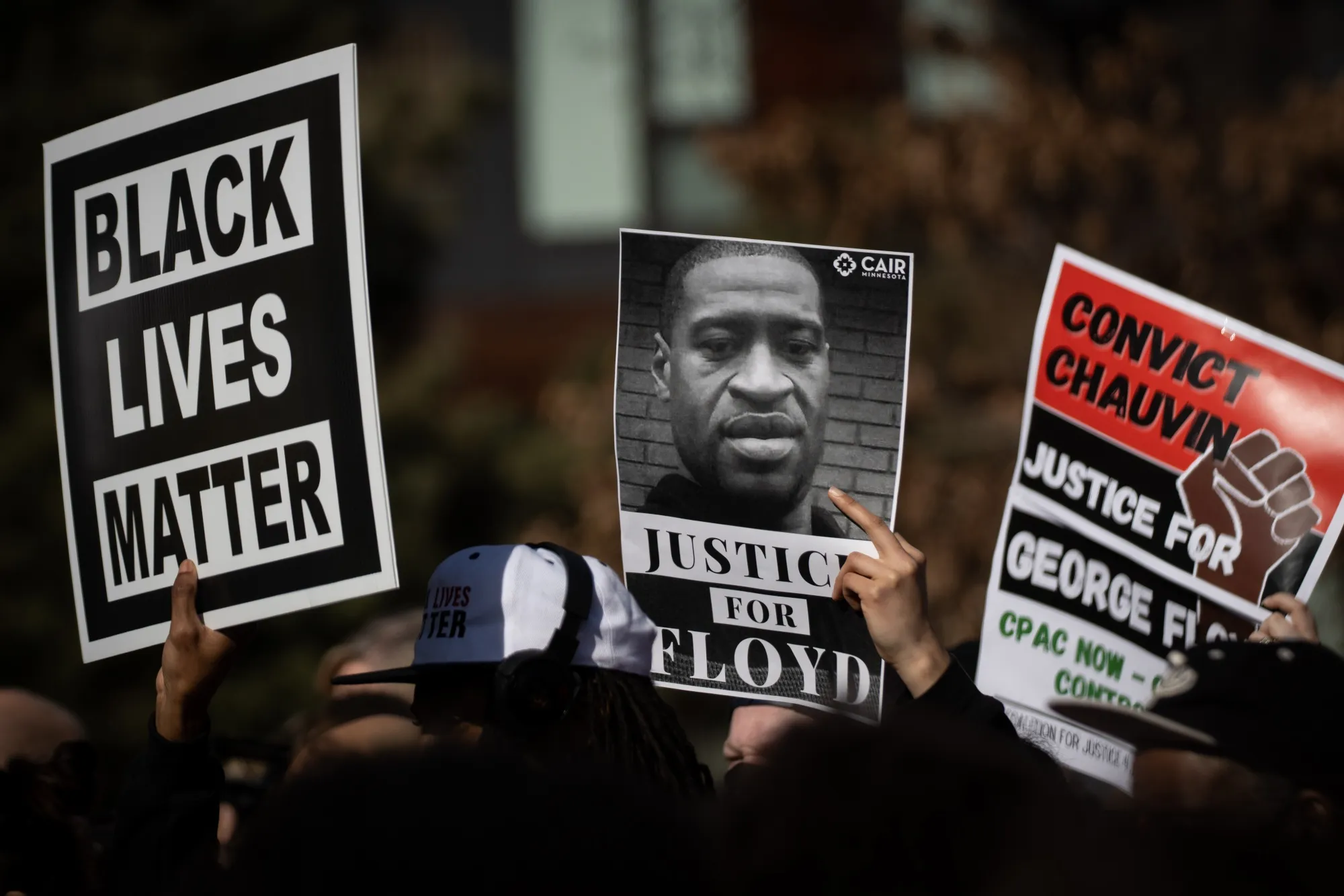 Demonstrators hold signs outside outside the Hennepin County Government Center in Minneapolis, Minnesota on March 8.