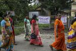 Women walk past a fever clinic&nbsp;in Boisar, Maharashtra.