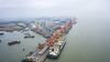 A bulk carrier sits docked at a terminal at the Port of Nansha, operated by Guangzhou Port Group Co., in this aerial photograph taken in the Nansha district of Guangzhou, China, on Thursday, April 11, 2019. The U.S. is open to facing "repercussions" if it doesn't live up to its commitments in a potential trade deal with China, U.S. Treasury Secretary Steven Mnuchin said, in a sign that the two sides are edging closer to an accord.