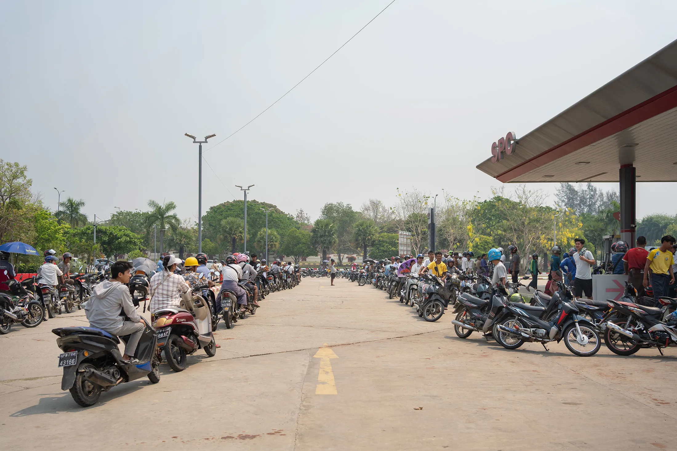 Hundreds of people wait in line&nbsp;for gasoline at a service station in Naypyidaw on March 27.