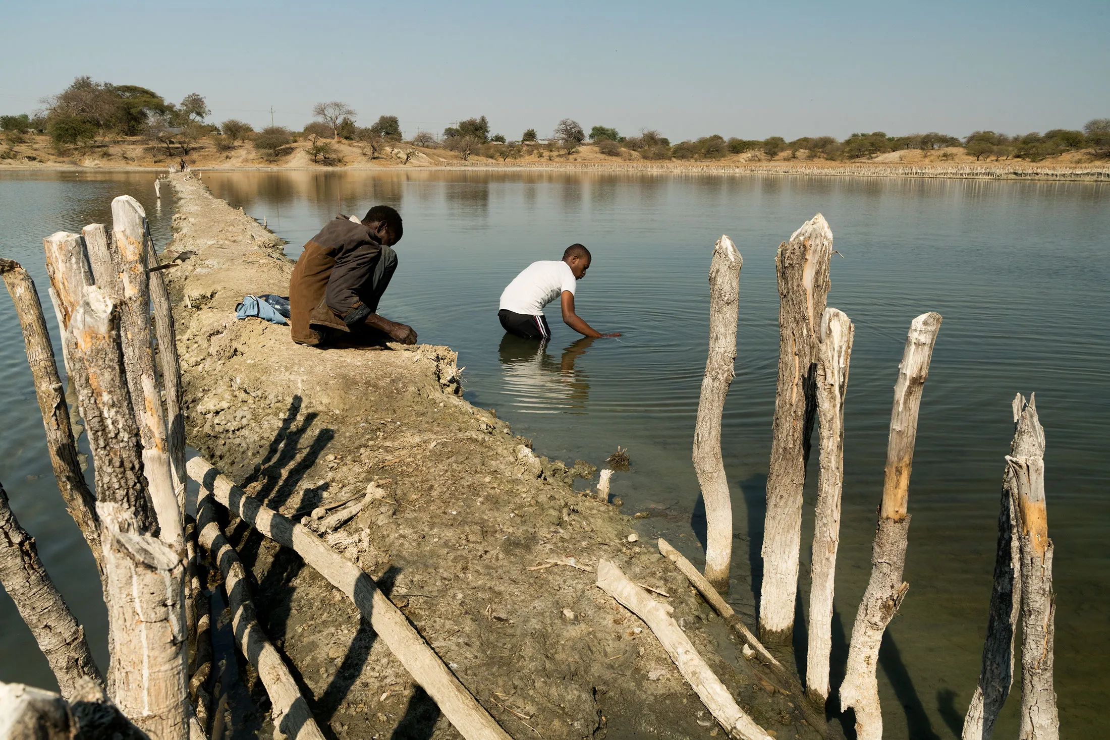 Grad student Karim Mtili (right) collects gas samples in Itumbula, Tanzania.