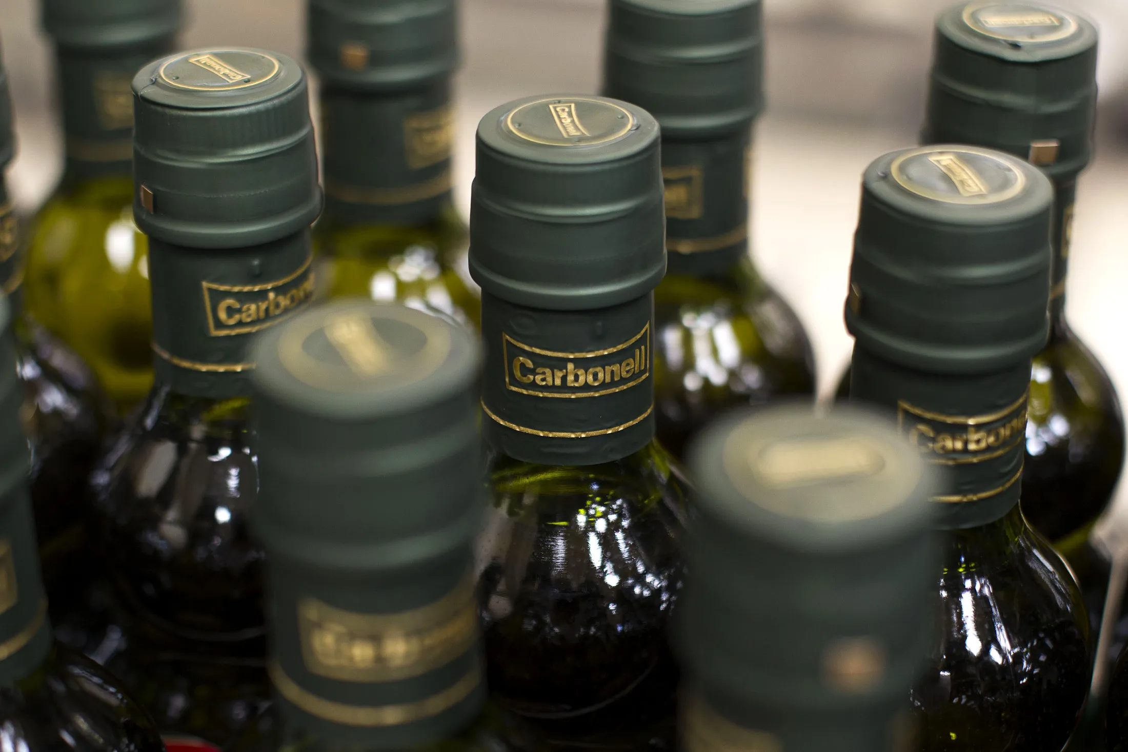 Bottles of Spanish olive oil move along the production line.