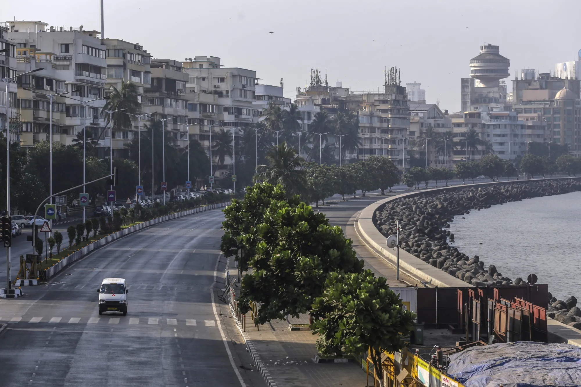 A vehicle travels on an empty street in the Marine Drive area during a coronavirus lockdown in Mumbai.