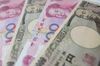 Chinese renminbi and Japanese yen bank notes are arranged for a photograph in Beijing, China, on Thursday, May 31, 2012. China and Japan have agreed to commence direct foreign exchange transactions of yuan and yen in Shanghai and Tokyo beginning June 1.