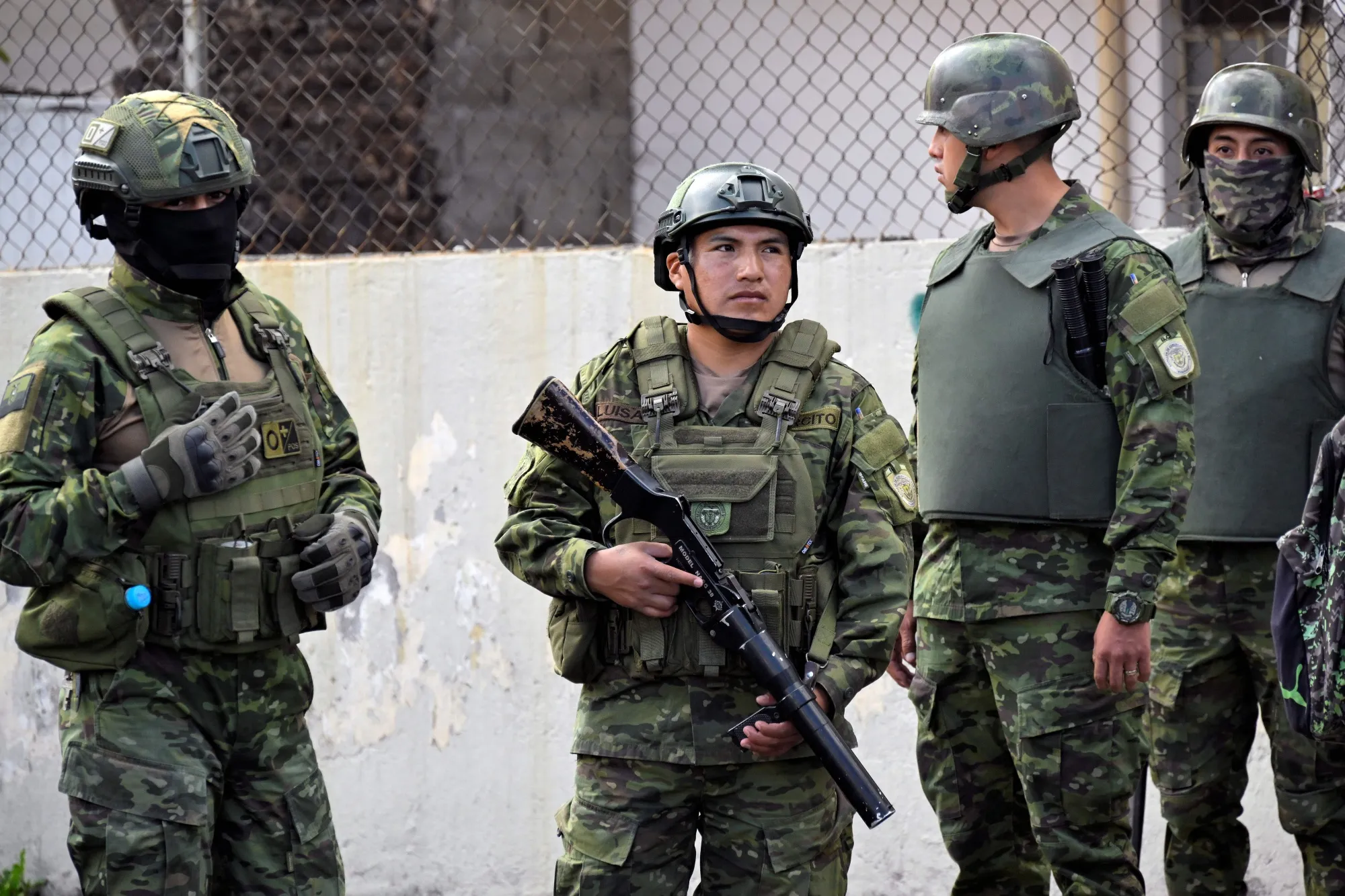 Ecuadorean soldiers stand guard outside a prison after a riot in Aug. 2023. The January escape of a notorious drug lord led to new reports of riots and highlighted the country’s struggles to control its prison system.