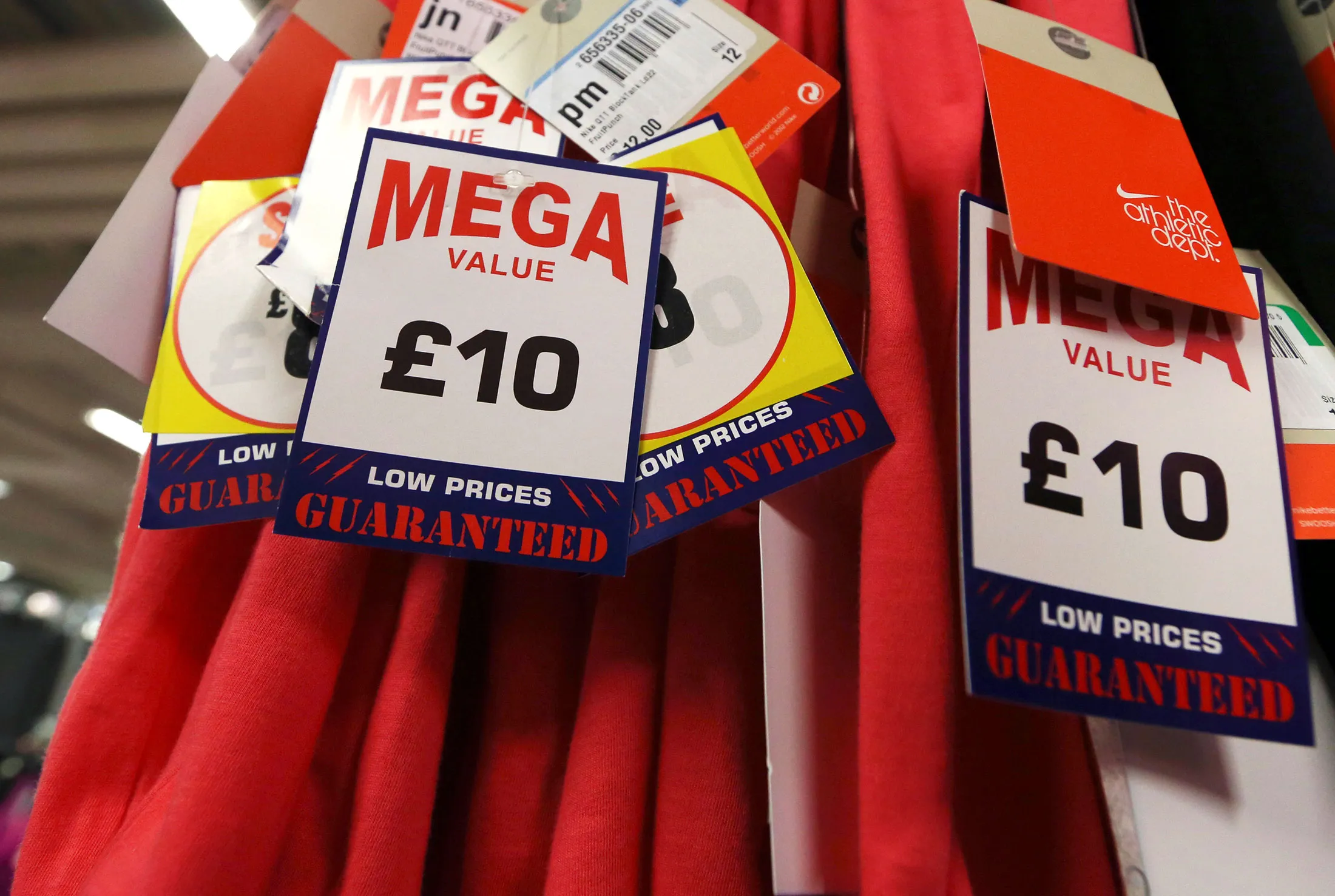 Price tags are seen displayed on sports clothing inside a Sports Direct store in London.
