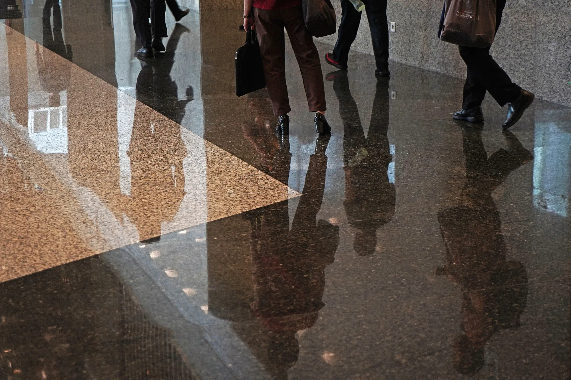 People walk through the lobby of the Indonesia Stock Exchange.