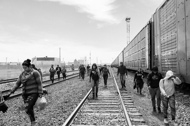 Migrants walk along a railroad track in Ciudad Juárez, Mexico.