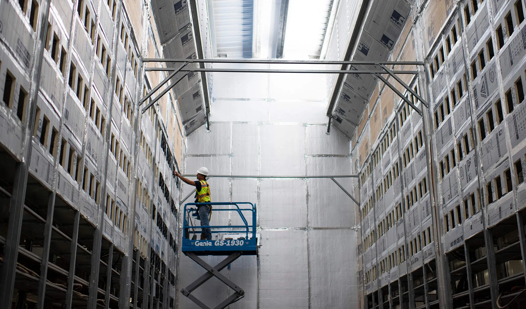 A worker installs a row of Bitcoin mining machines at a mining facility in Rockdale, Texas.