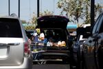 A customer loads groceries into a car outside a supermarket in Phoenix, Arizona.&nbsp;